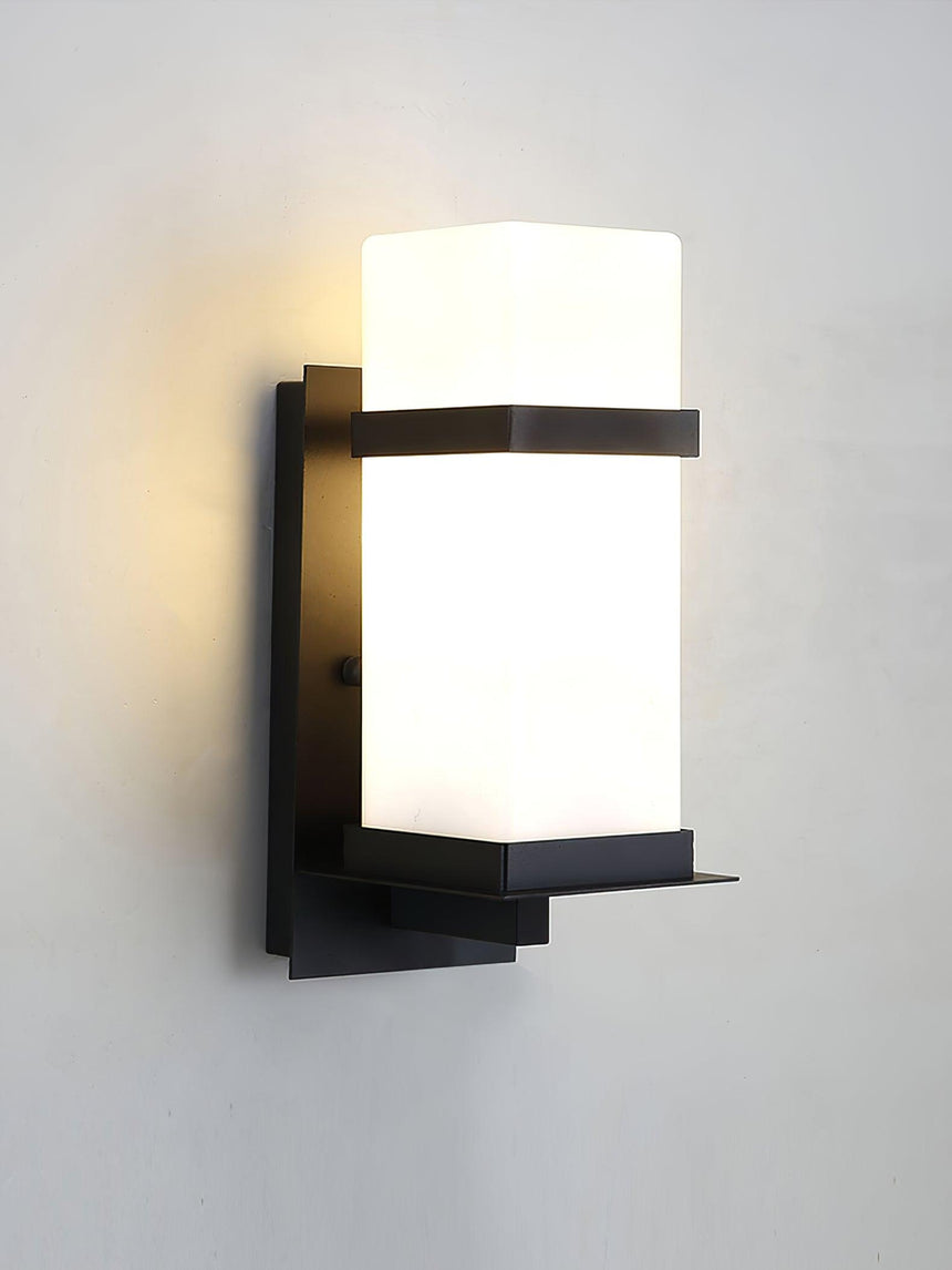 The light lit on a gray wall, the glow even across the frosted glass