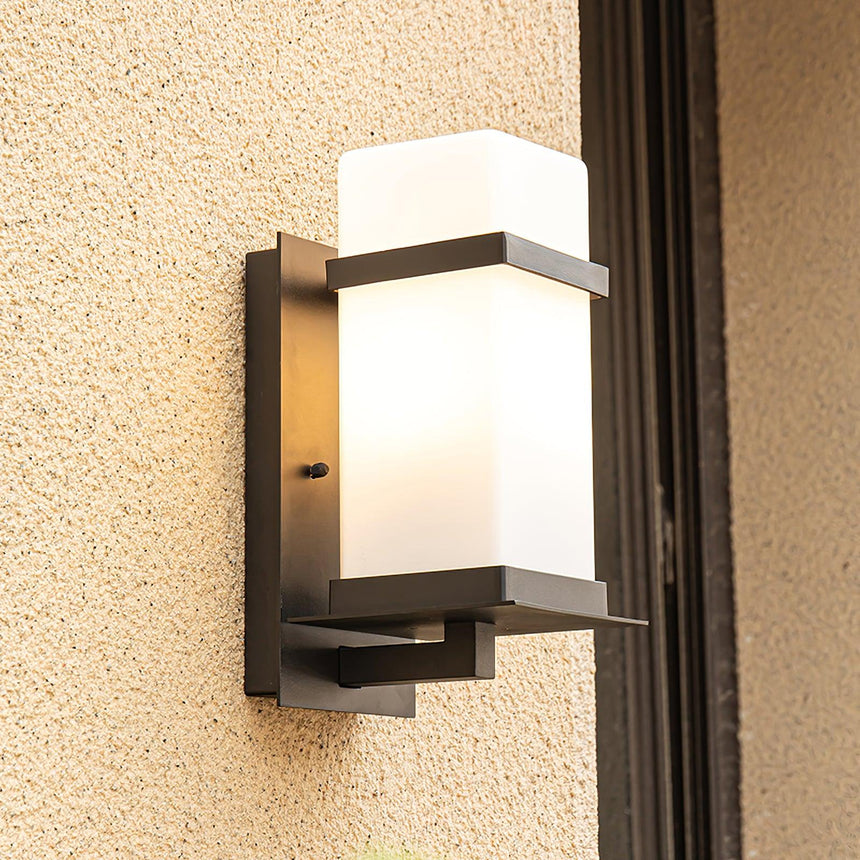 The light on sand colored render beside a dark door frame