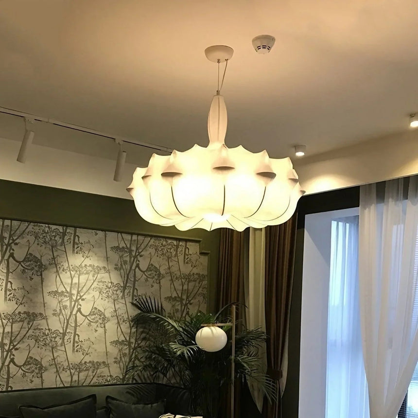 Layered silk shade lit against a dark patterned wall