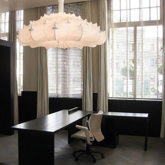Layered silk pendant in a lounge with armchairs below it