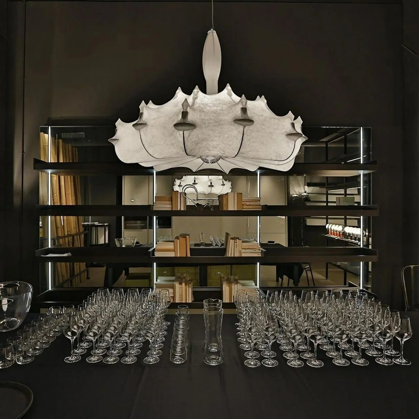Row of layered silk pendants above a long table