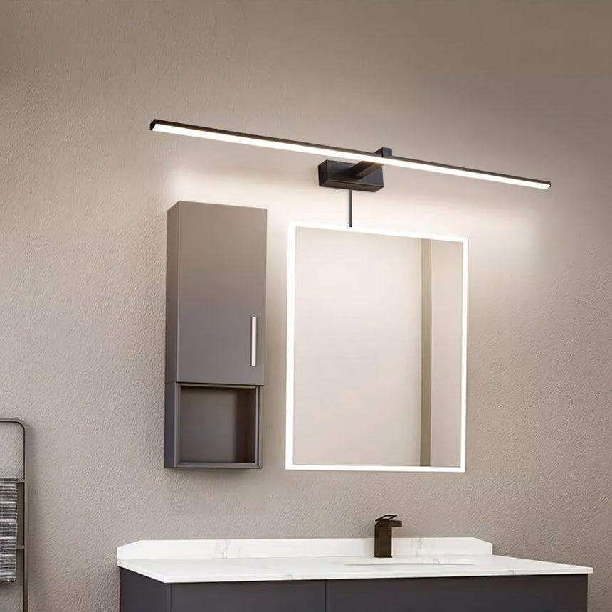 Dark bar lit above a lit mirror beside a tall cabinet over a wide basin