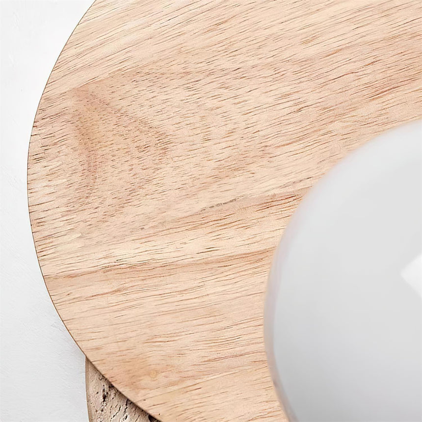 Close view of the wood grain on the front disc beside the glass orb