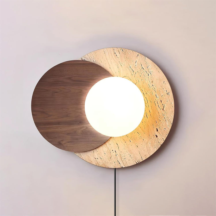 Walnut disc version lit warm, the white orb glowing at the overlap