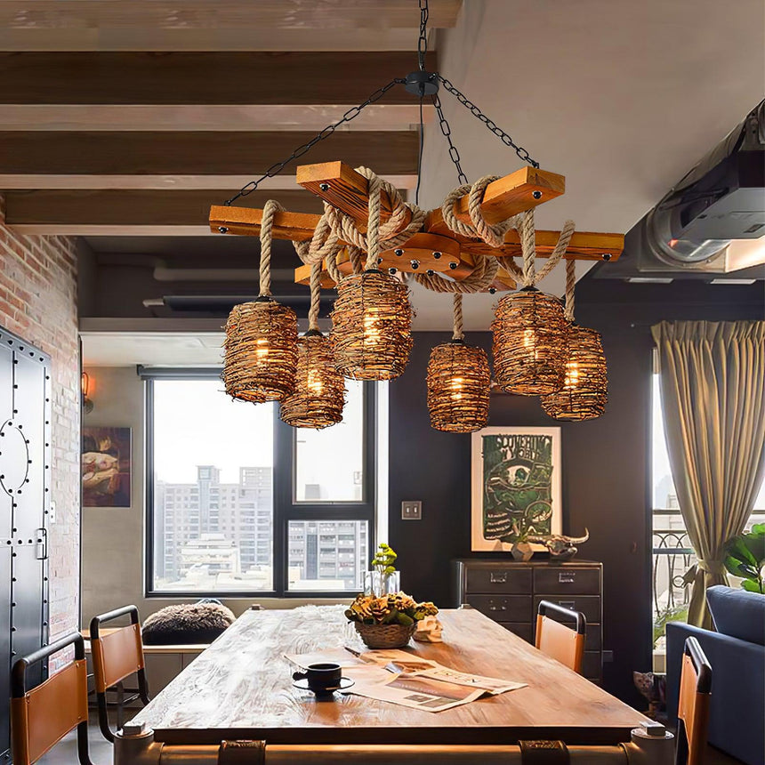 Lit above a long table and chairs in a room with a city window and a dark cabinet