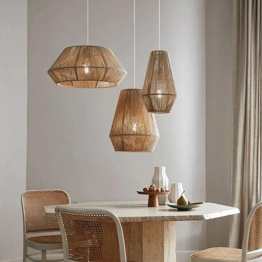 Flat woven wicker dome hung above a table with a vase