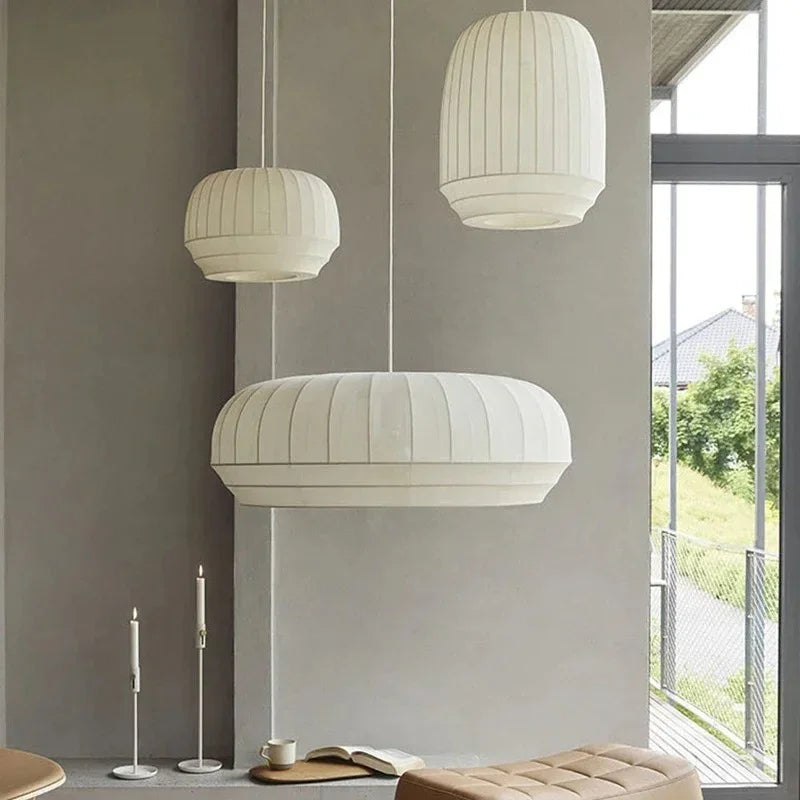 Tall and wide knitted shades hung together in a pale room
