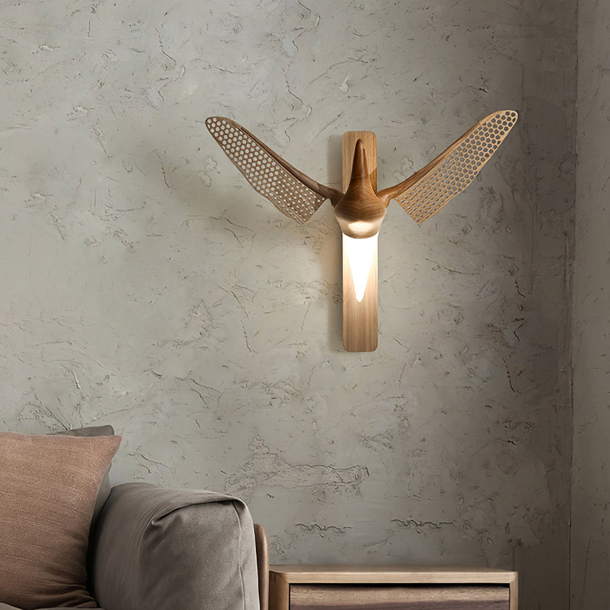 Sconce lit above a low bench beside cushions on a plaster wall