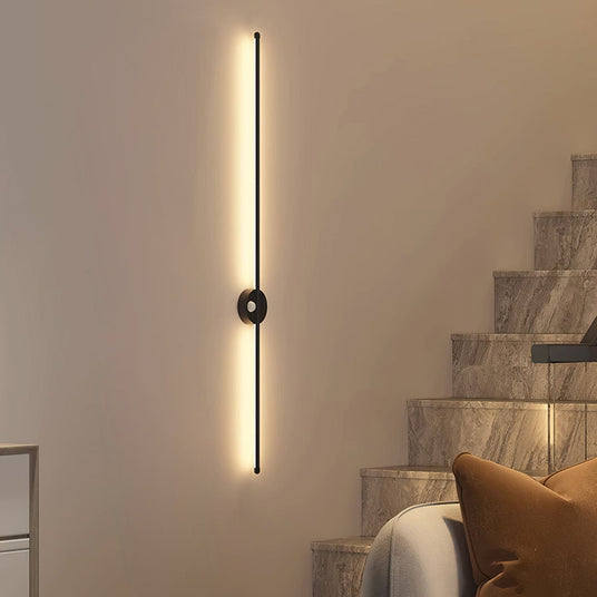 Lit beside a stone staircase above a bench with an amber cushion on it