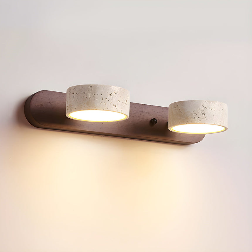 Two travertine discs on a short dark walnut bar, seen straight on