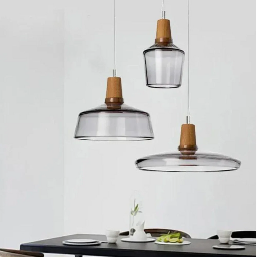Three smoked glass pendants of different shapes hung above a counter
