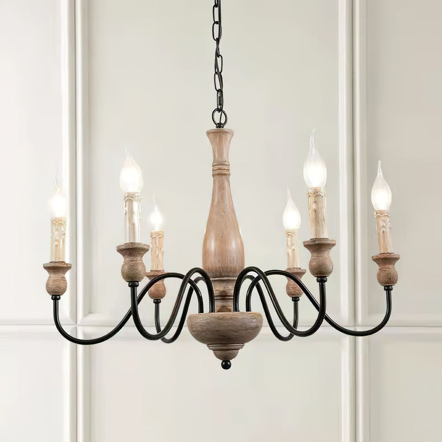 The six candle bulbs lit against a paneled white wall and a doorway