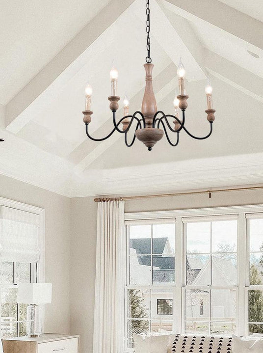 Hung under a white vaulted ceiling in a bright room with tall windows and a pale sofa