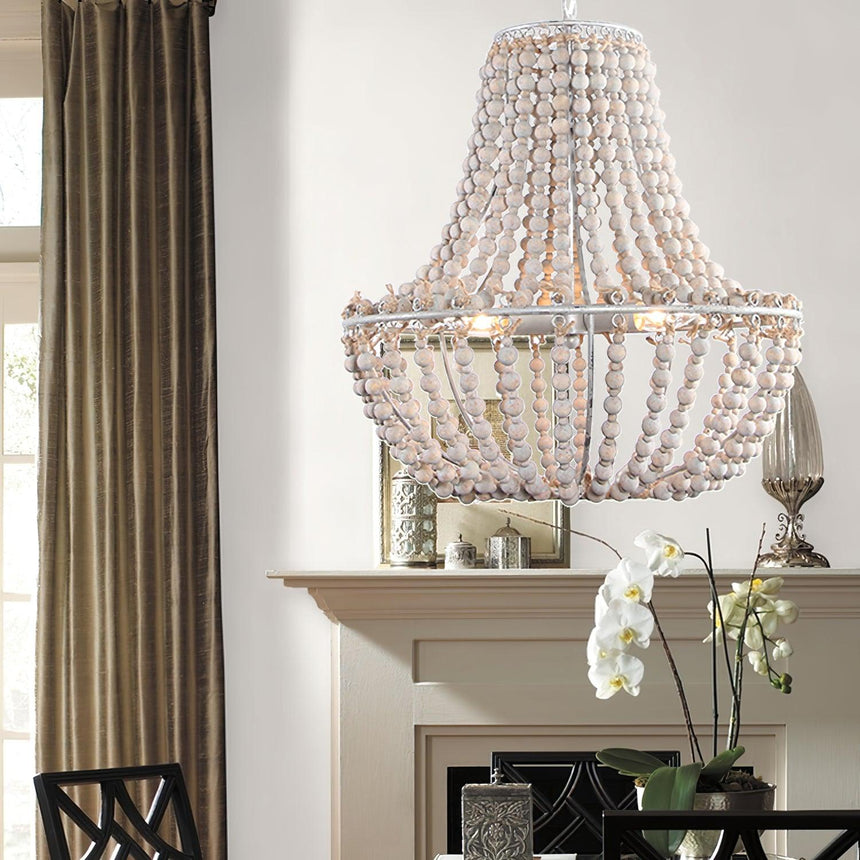Lit above a mantel with an orchid and candles beside long curtains