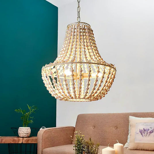 Lit against a teal wall above a pink sofa with cushions, candles and plants