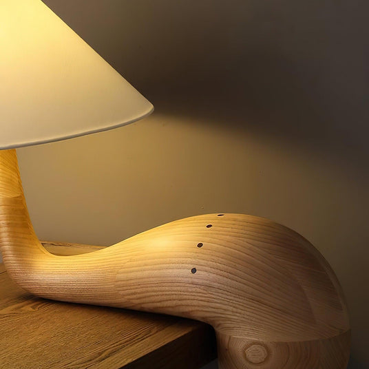 Close view of the carved wood arm and the grain running along it