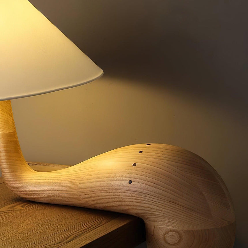 Close view of the carved wood arm and the grain running along it