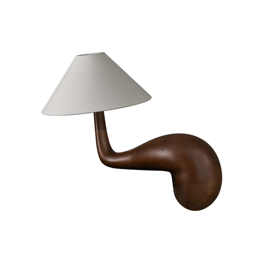 Walnut wood desk lamp seen from the side against a plain ground
