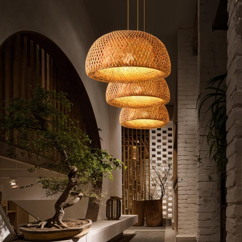 Shades lit in a row beside an arched doorway with a bonsai on a stone ledge