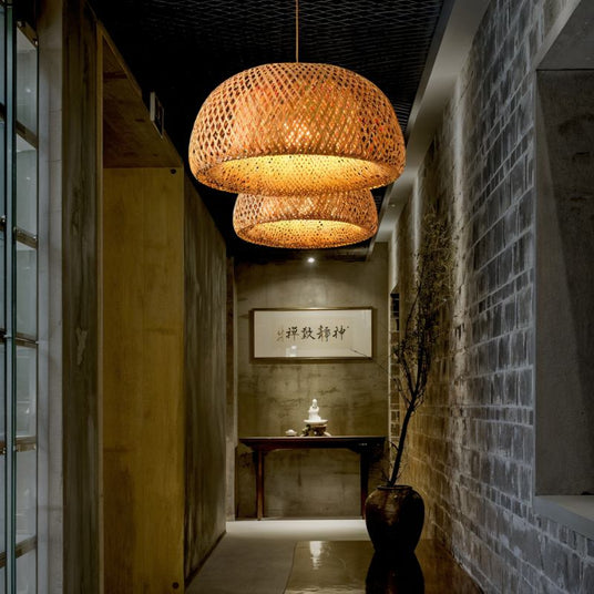 Two of the shades lit down a stone corridor above a console table and a tall vase