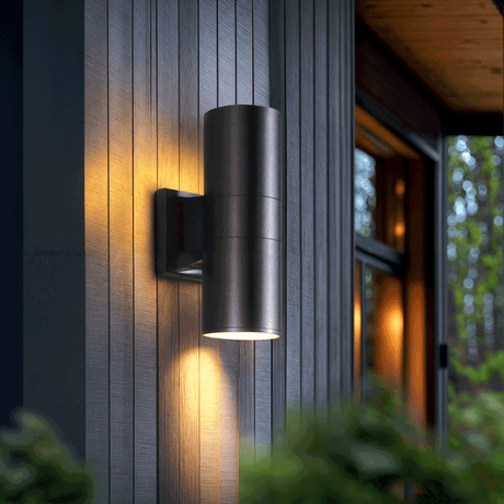 Twin-head aluminum LED wall lamp mounted on an outdoor entryway wall with soft diffused acrylic glow