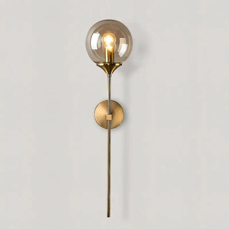 Glass orb LED wall lamp with iron frame mounted in a modern bedroom with neutral decor