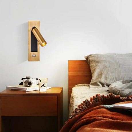 Aluminum LED wall sconce with warm 3000K glow mounted beside a minimalist bedroom bed for reading