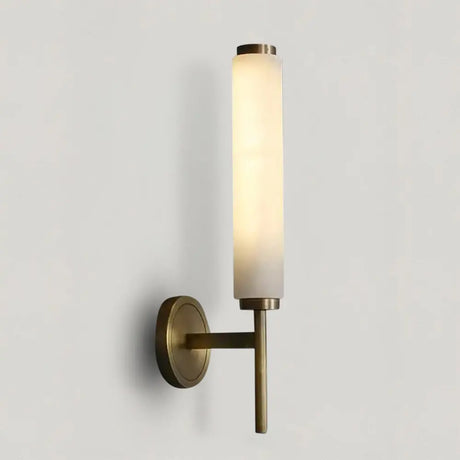 Rowan marble and copper LED wall sconce casting a warm ambient up-light glow in a modern living room