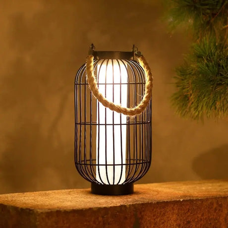 Outdoor LED metal lantern light with solar panel glowing on a garden patio at dusk