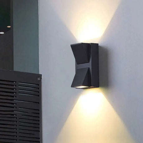 Aluminum dual head LED outdoor wall sconce mounted beside a modern home entryway