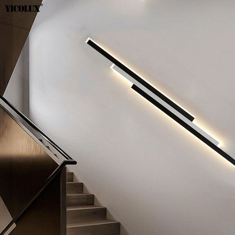 White outdoor LED wall sconce with three rectangular acrylic panels mounted on a modern porch entryway wall