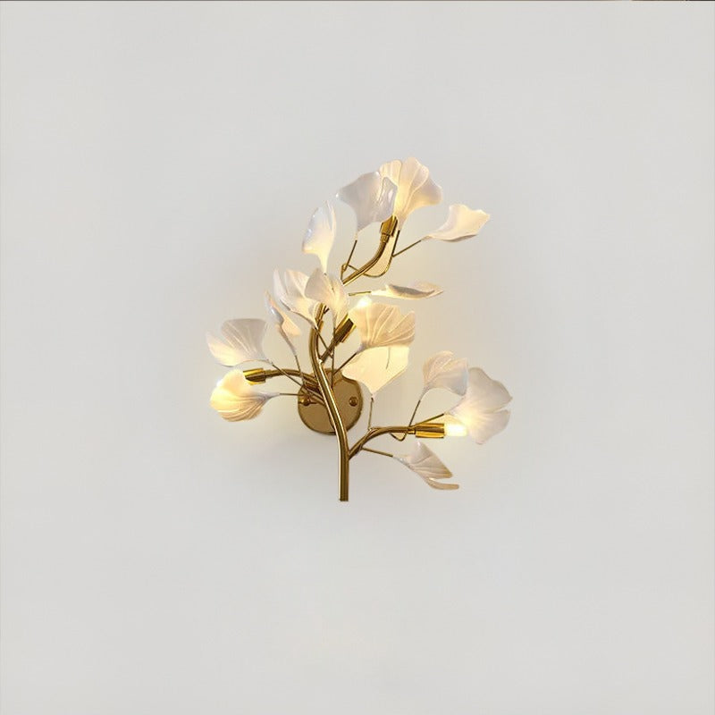 Acrylic LED leaf wall sconce with ginkgo design mounted on a modern bedroom wall casting warm ambient light