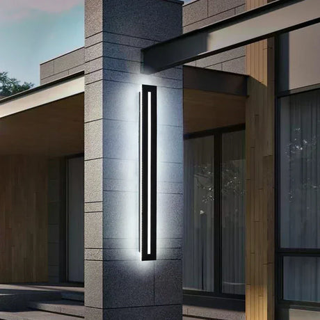 Polished chrome LED wall lamp with long profile mounted in a modern dining room with neutral walls