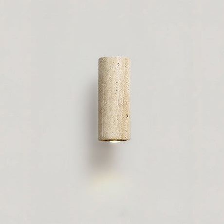 Travertine wall sconce LED with ebony finish casting soft ambient glow in a modern hallway