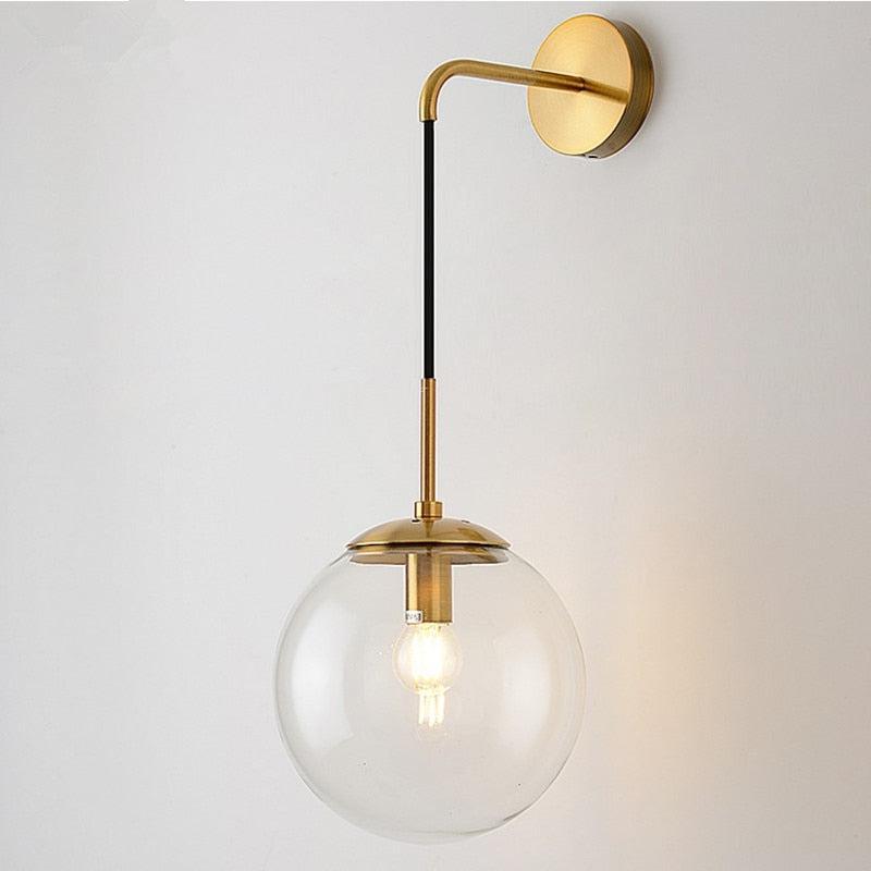 Black wall sconce hallway ambient glow with glass globe shade in modern industrial interior decor