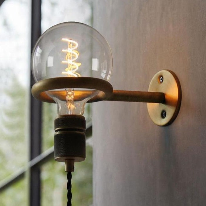 Brushed copper plug-in industrial wall sconce with exposed bulb and knob switch for home accent decor