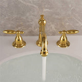 Vintage brass double-handle bathroom faucet installed in a bathroom setting