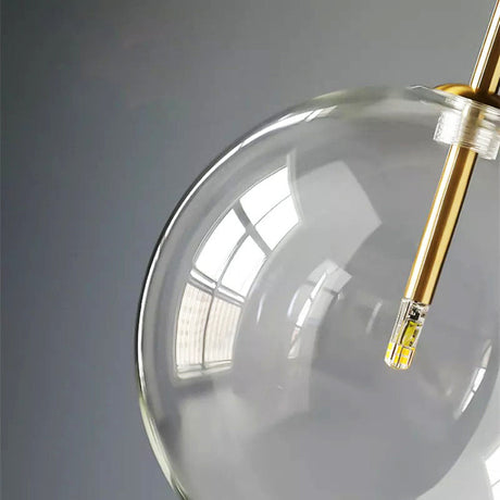 Pendant light casting warm glow through glass sphere