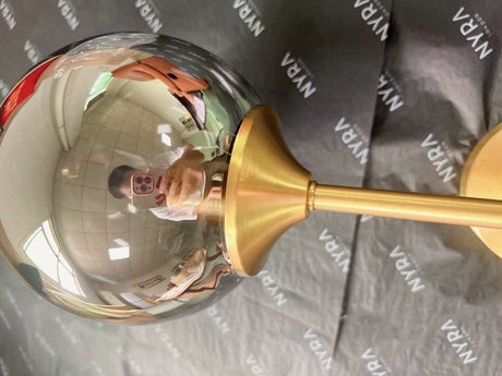 Orb wall light shown in a bedroom setting