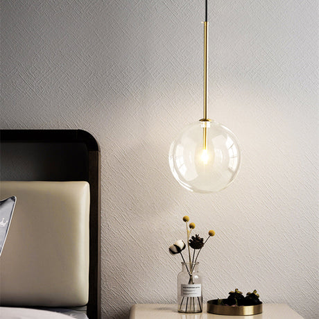 Gold pendant light illuminated in kitchen setting