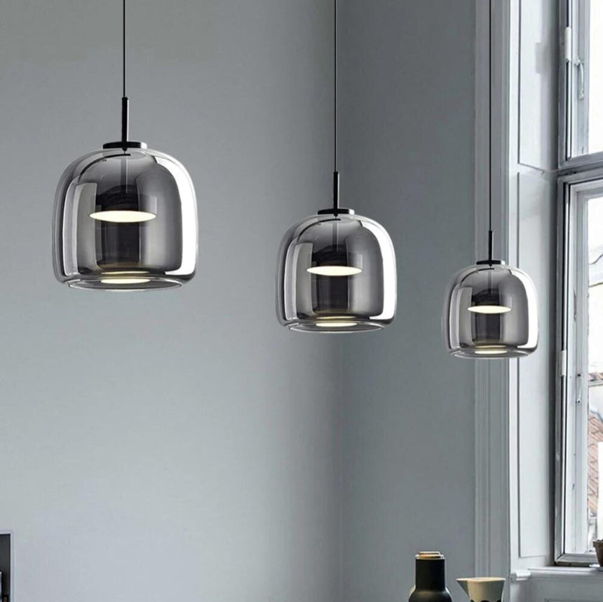 Black glass pendant light installed above table