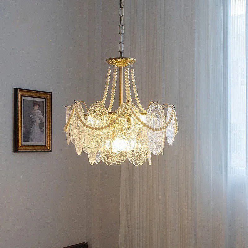 The smaller fitting lit in a corner beside a framed portrait and a curtain
