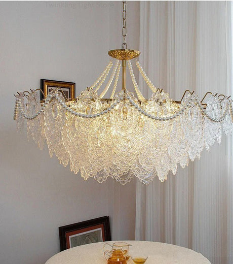 The lit fitting above a round white table with a picture frame resting on it