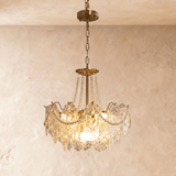 Style A at mid size, three tiers of pressed glass lit from inside the brass frame
