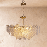 Style B at mid size, the petal tiers lit and hung from a brass chain