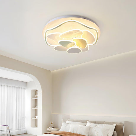 Cloud motif ceiling light above a bed in a room with arched wall niches