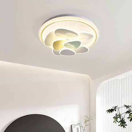 Cloud motif ceiling light lit in a room with a round mirror and a plant