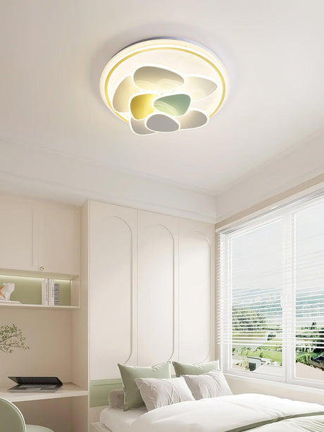 Cloud motif ceiling light lit in a bedroom with a window and pale bedding