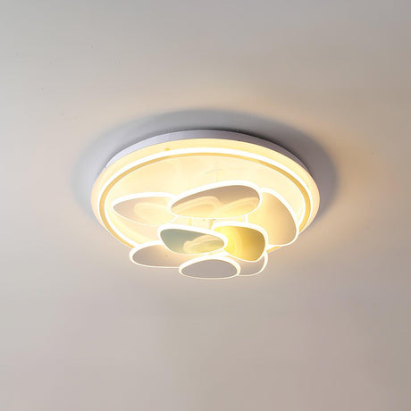 Cloud motif ceiling light lit from a low angle showing the layered shapes