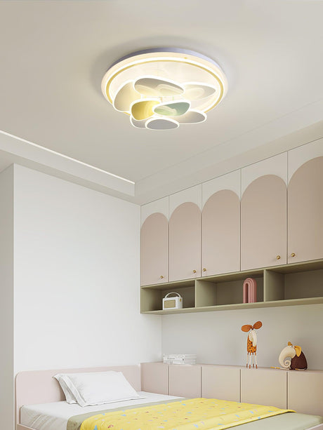 Cloud motif ceiling light above a child bed with arched cabinet doors
